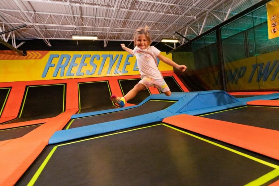 young girl jumping on a trampoline at urban air