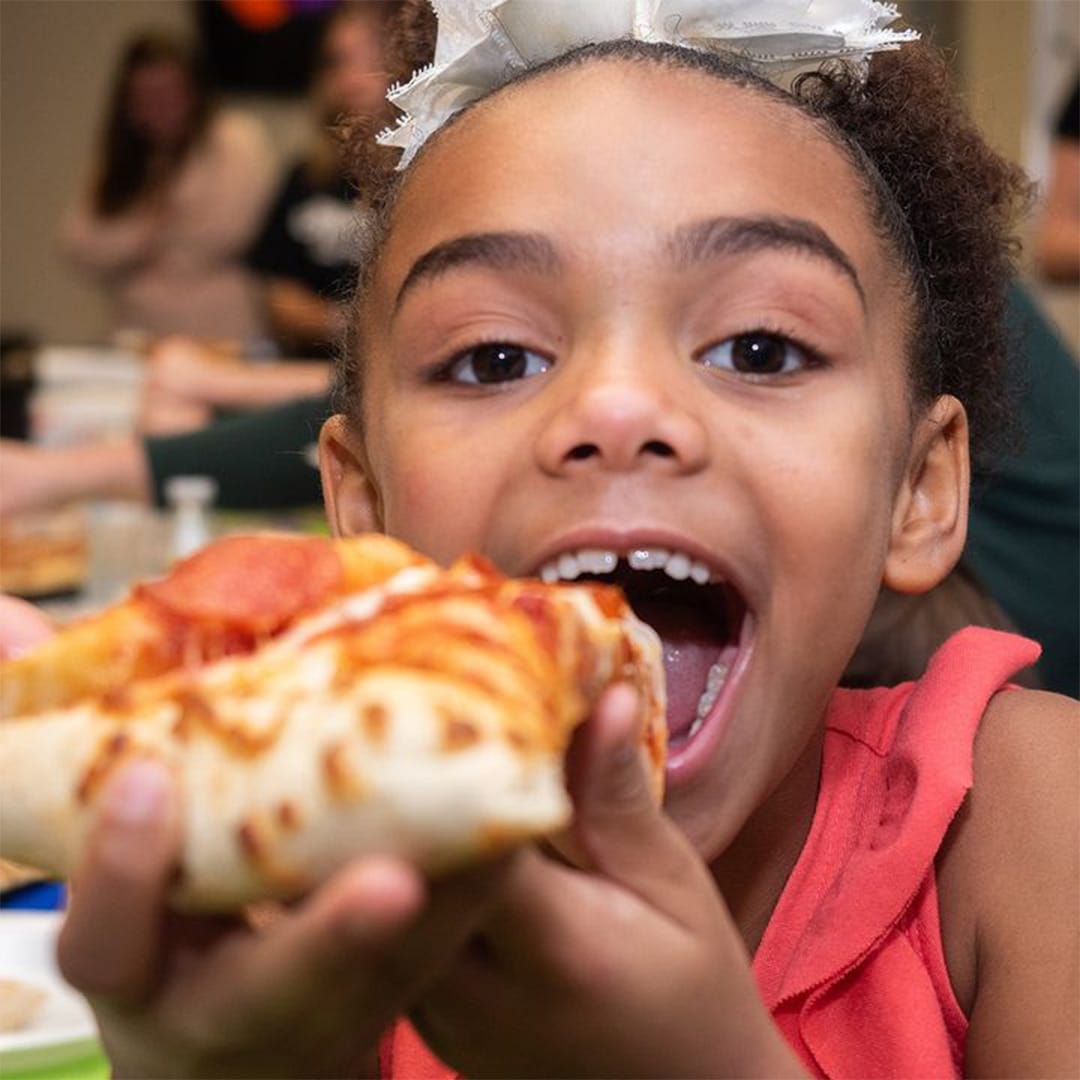 girl eating urban air pizza