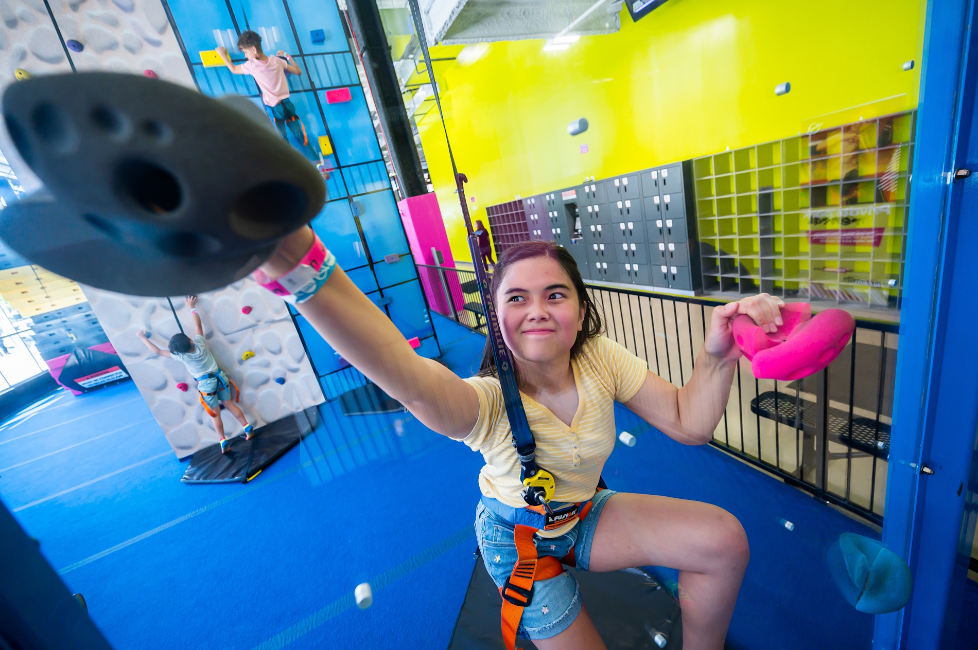 girl having fun on a rock climbing course
