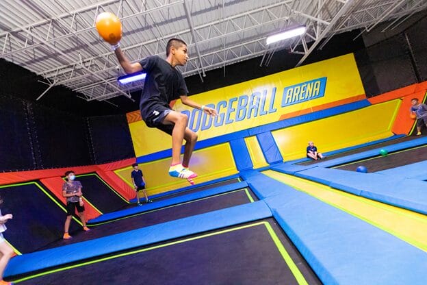 A young boy is playing with ball at urban air