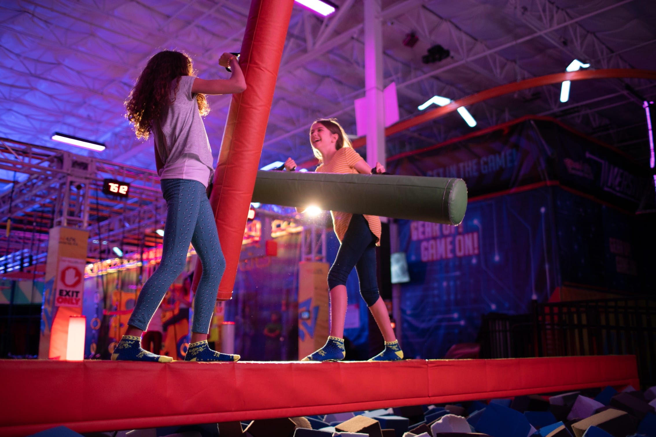 two girls having fun on a battle beam
