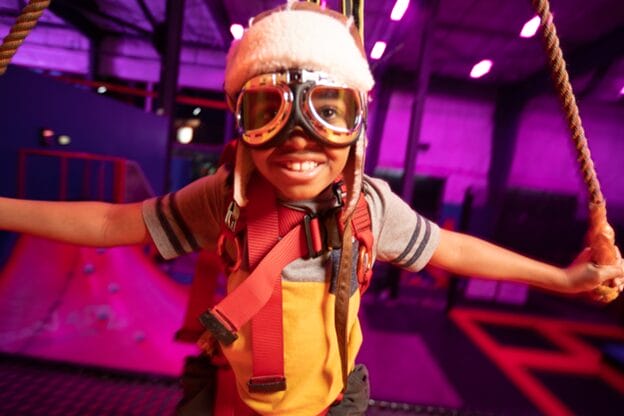 boy on urban air sky rider zipline