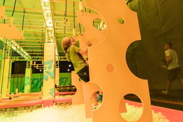 boy on urban air obstacle course