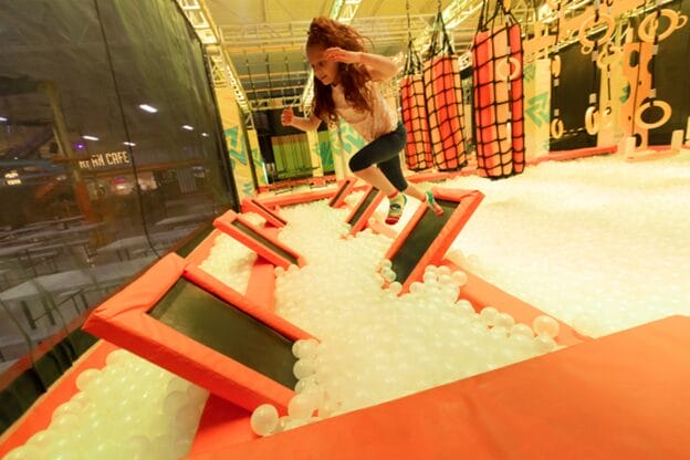 girl bouncing across springboards