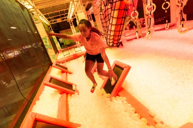 girl bouncing on a series of springboards