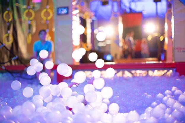 A child playing with white balls