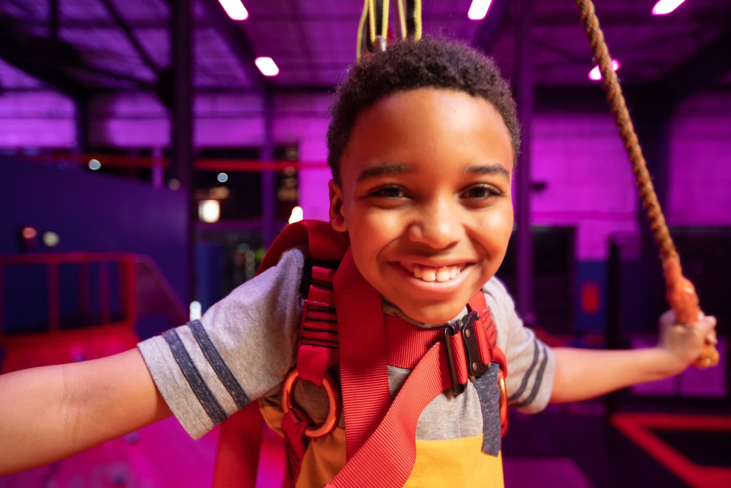 A child smiling at urban air adventure park